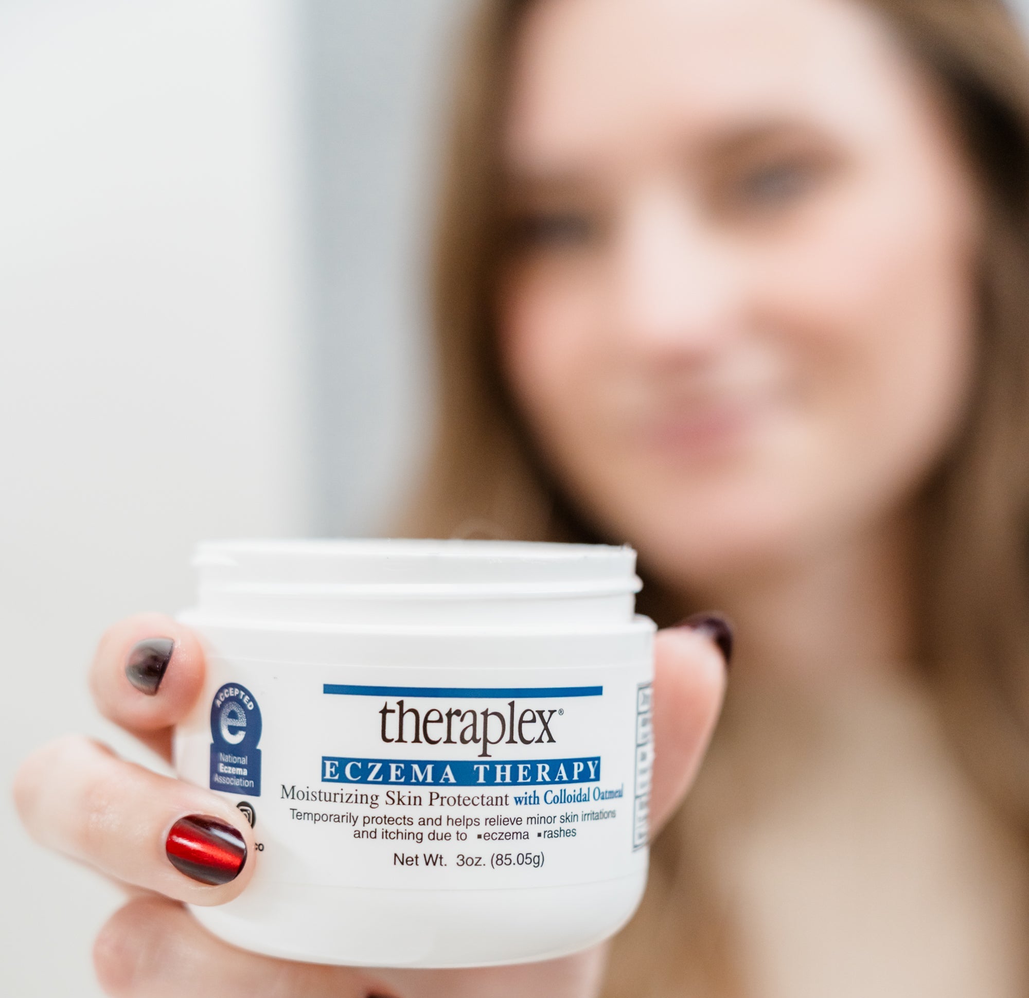 Person holding a Theraplex jar with a blurred background